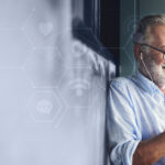 Elderly man watching an online movie from his phone